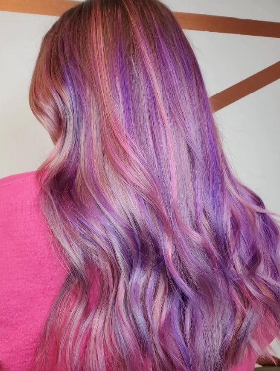 beautiful long locks are adorned with streaks of purple and pink