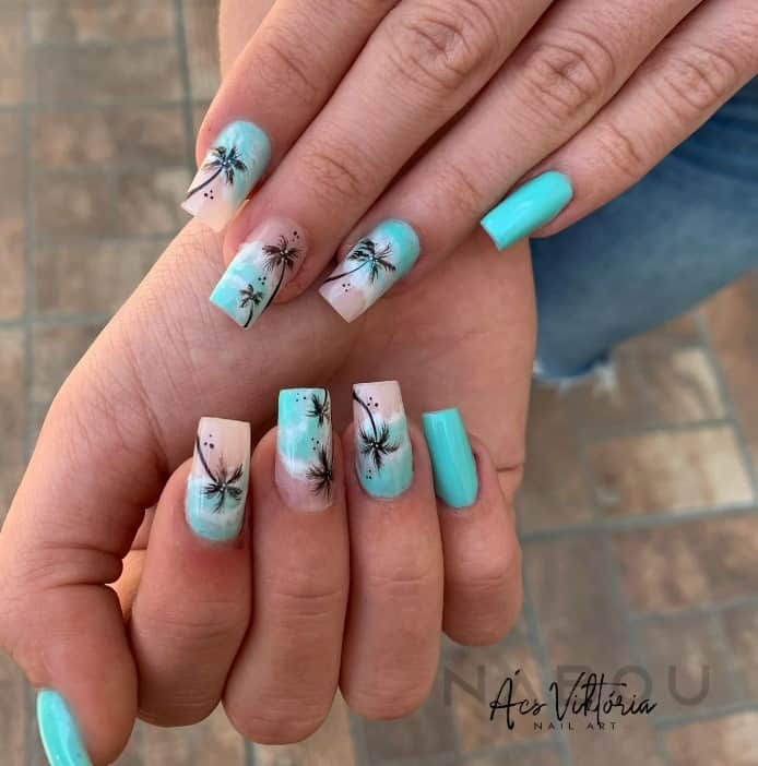 light blue set that features nude accent nails with black palm trees and soothing ocean waves
