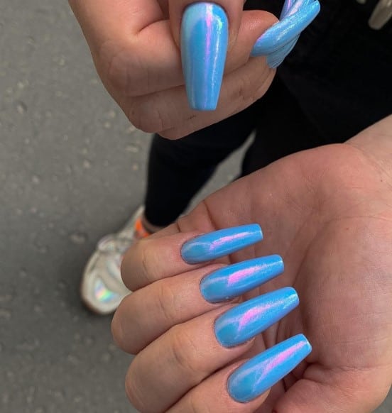 A woman with pale blue coffin nails of blue holographic nails.