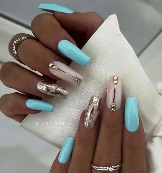 A woman's hand with chrome foil and diamonds as accents, this design offers high-powered glare to light-blue and translucent white nails