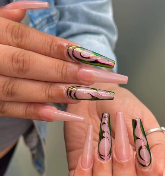 nude pink nails look bold and edgy with a design featuring chrome swirls, which change in color when the light hits them