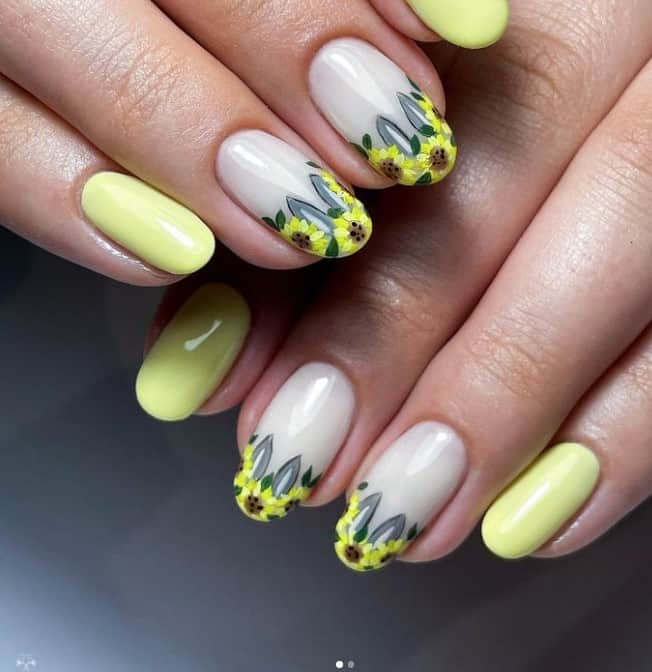 A woman's yellow Easter nails with sunflower and bunny ears design on the accent nails