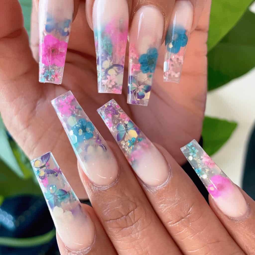 creamy white base to clear tips filled with large glitter flakes, cute butterflies, and flowers in pink and blue