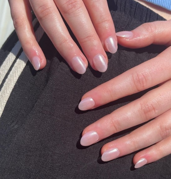 A woman's hands with nude base with a glimmery subtle topcoat
