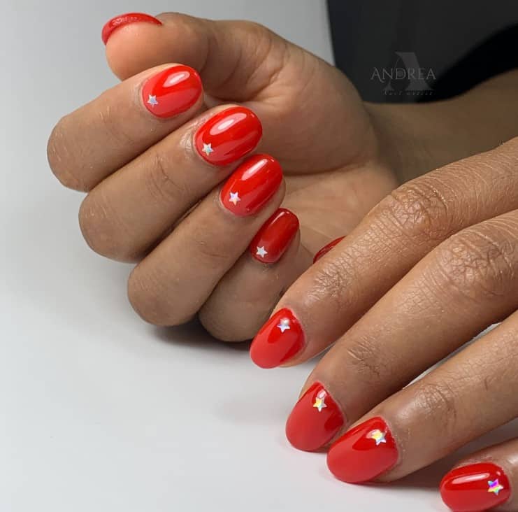 A woman's short red set with sparkly mini silver stars