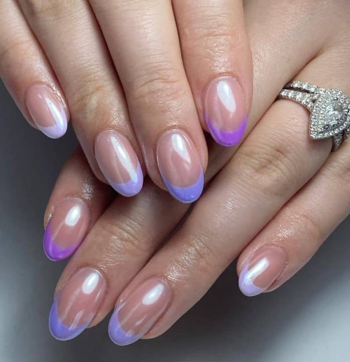 A woman's hands with nude base with thick purple gradient French tips