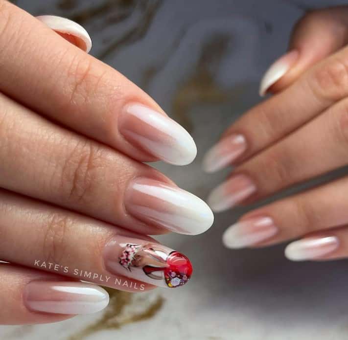 A woman's minimalist mani with cartoon nail art done in red and brown gradients, with yellow, white, and black touches