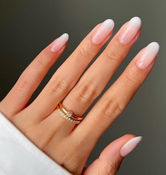 A woman's hand with subtle transition between the pink base and the soft white tips