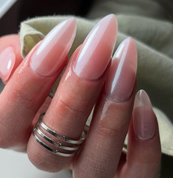 A woman's nude-pink nails that peter out to tips that nearly look translucent