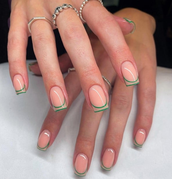 A woman's hands with
traced French tip over pink nails