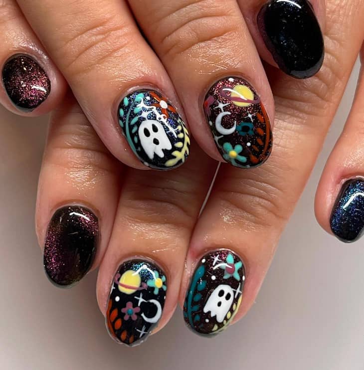 A woman's short nails painted in black and some of which are decorated with ravishing cat-eye designs