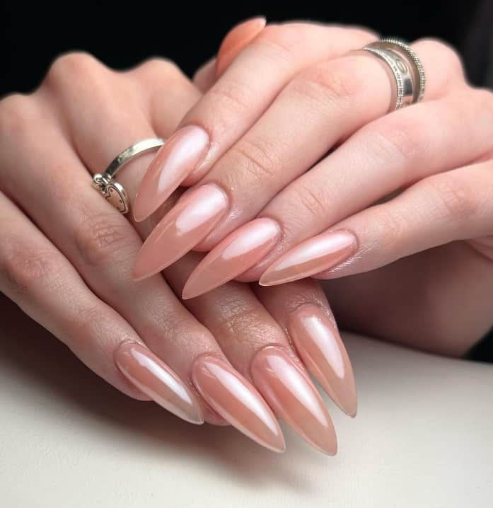 A woman's hands with translucent light nude color nails.