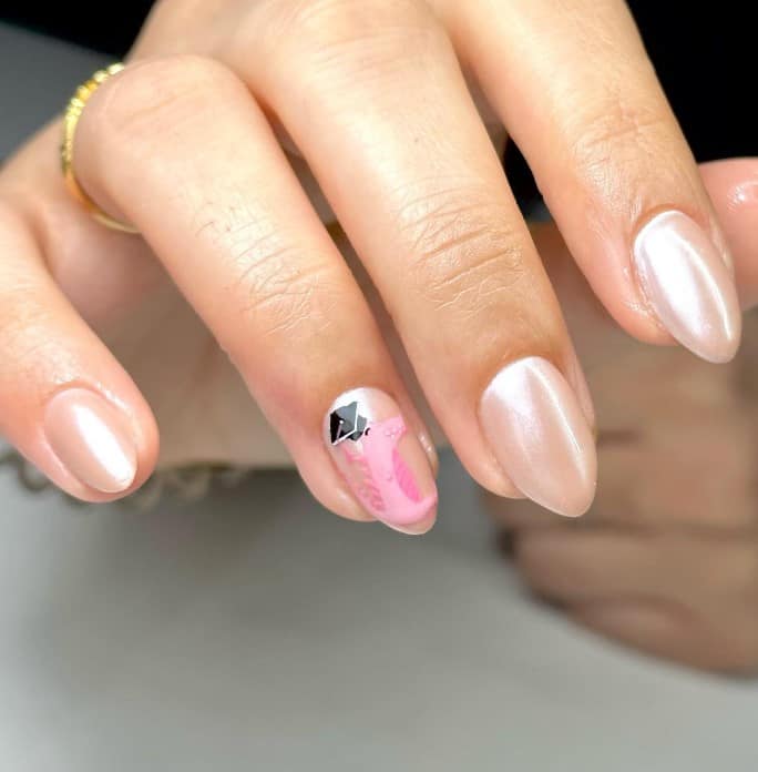 A woman's pink and white nails with a flamingo design and graduation cap.
