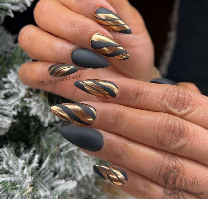 A woman with black matte nails make a dramatic background for streaks of gold