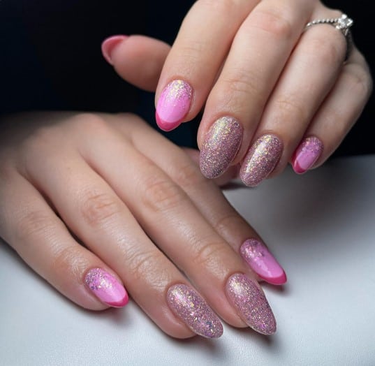 A woman's mid-length oval nails with a soft pink base and a sultry dark pink French tip
