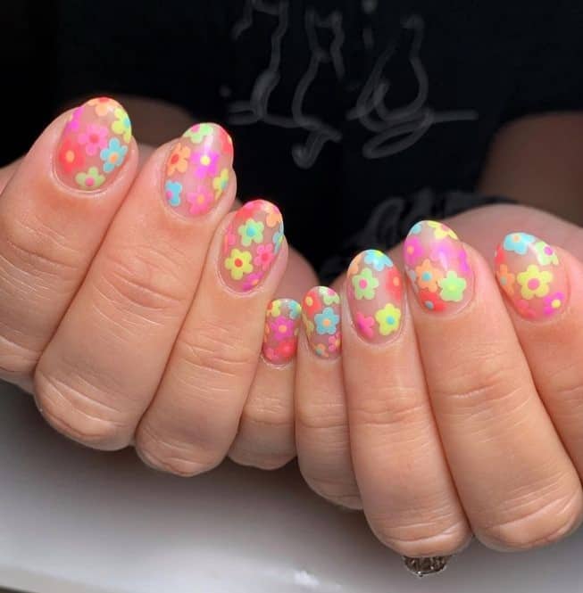 A woman's hand feature pastel red, orange, yellow, green, aqua, and pink — each used to paint a collection of charming five-petal flowers on a clear base