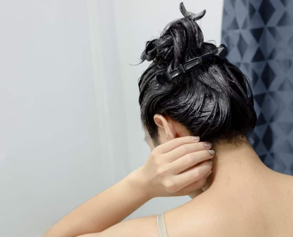 A woman doing a diy hair dye 