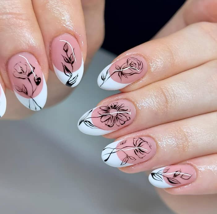 A woman's nails featuring delicate sketches of foliage, carnations, roses, daisies, and peonies in black atop nude nails sporting crisp white French tips