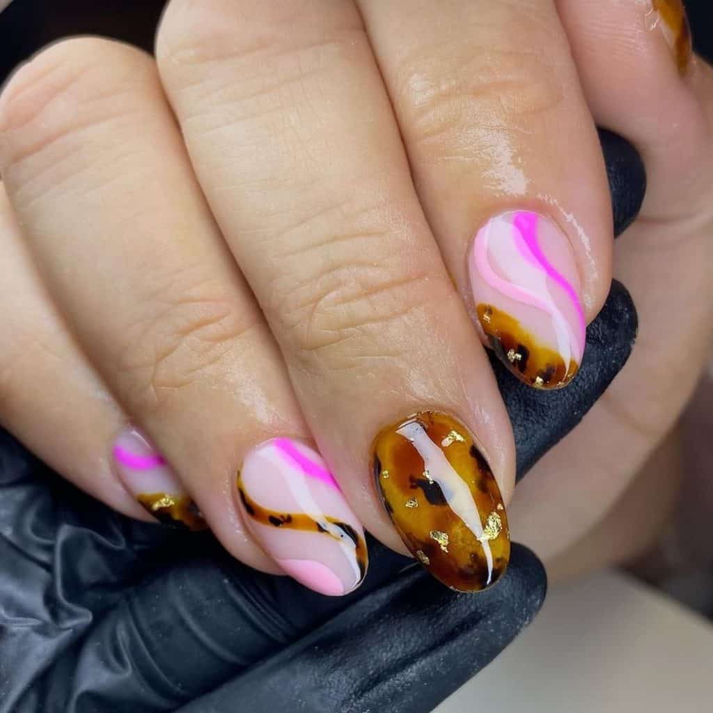 A woman's hand with a pink tones and tortoiseshell patterns to create swirls on an off-white base