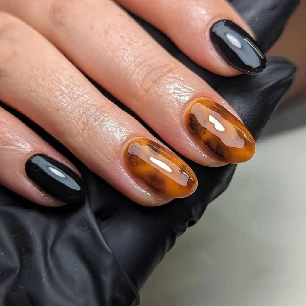 A woman's hand with tortoiseshell accents paired with sleek black nails