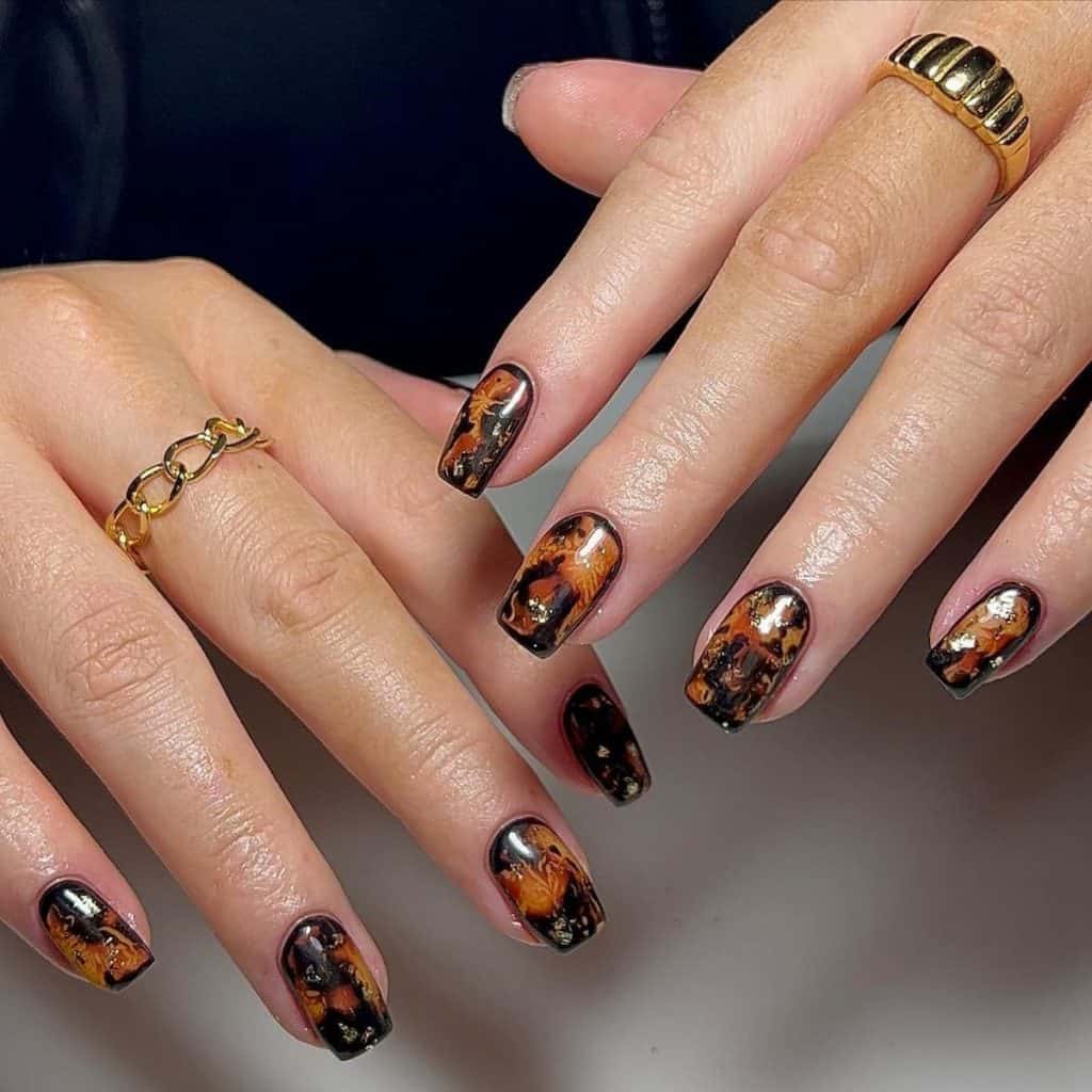 A woman with tortoiseshell nails encased in a deep black border
