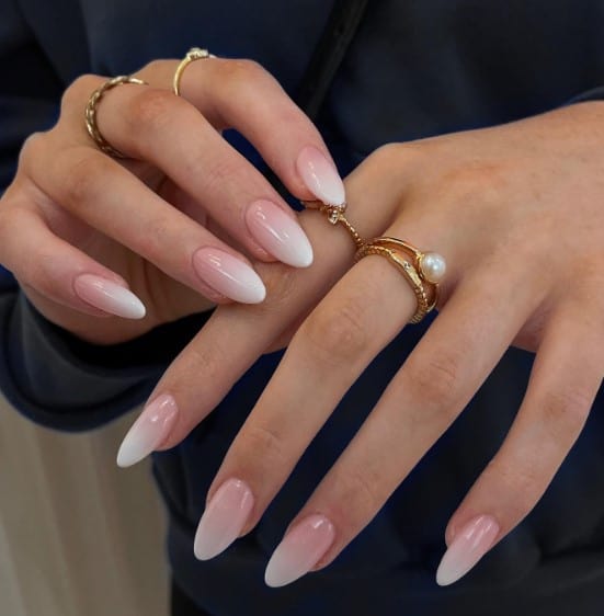 These pinkish nude and white ombré nails create a clean and sophisticated look that's effortlessly chic.