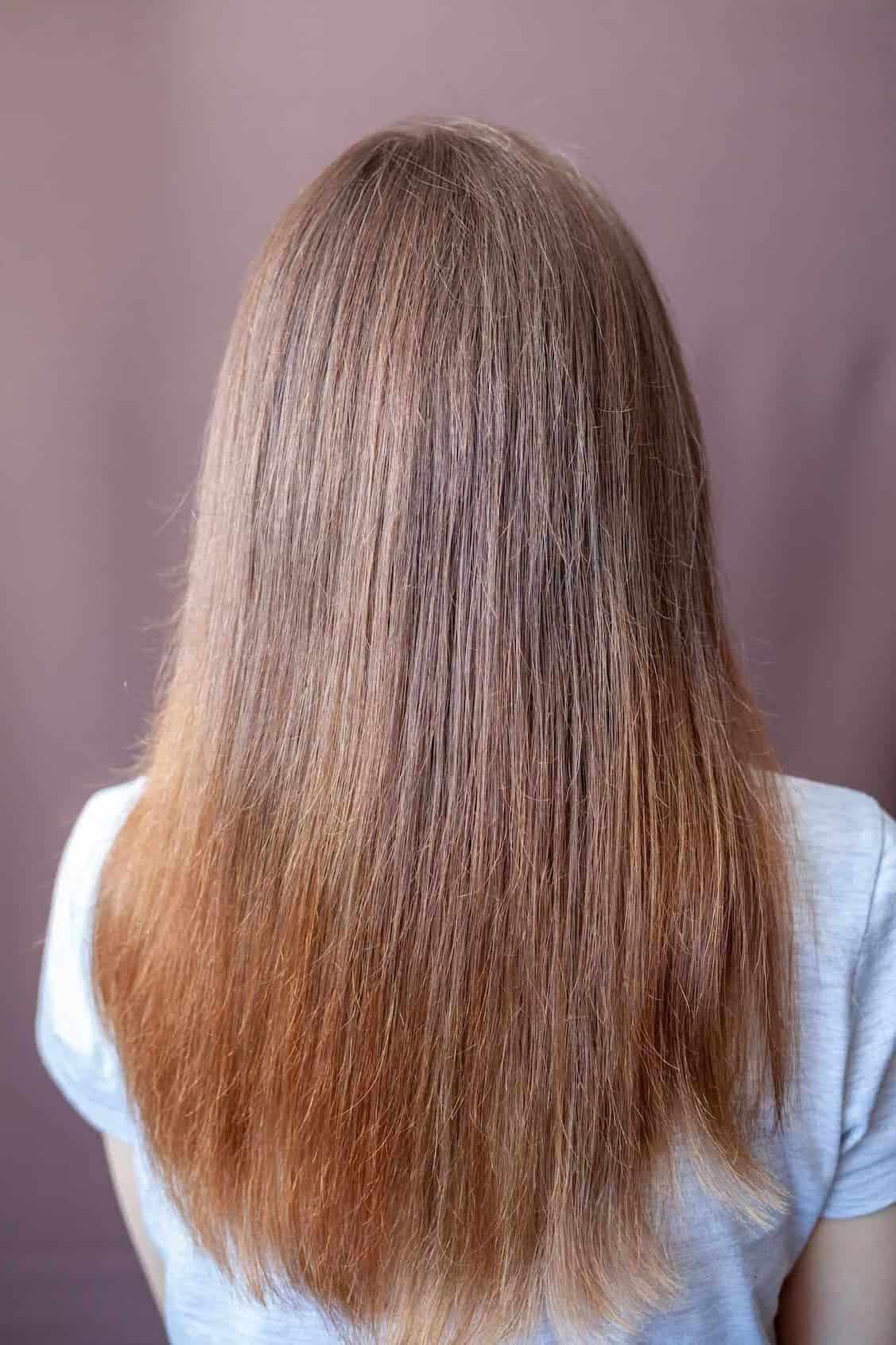close up photo of a woman's straight hair with layers