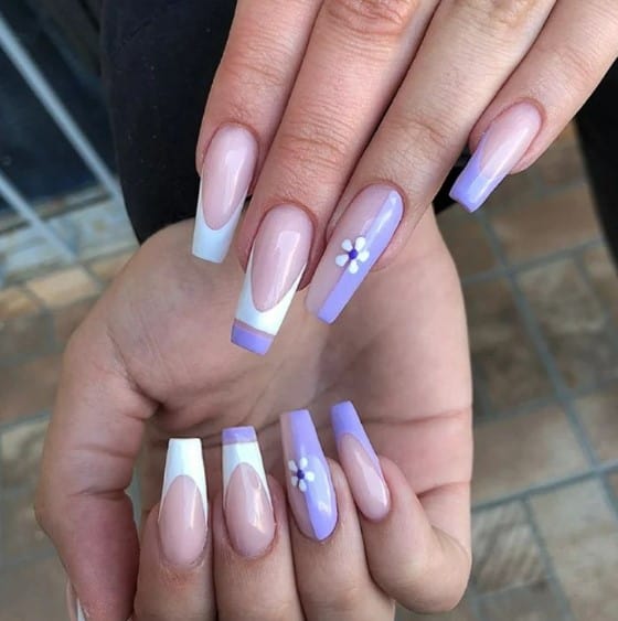 A woman's haze of lavender and white with these nude coffin nails featuring a sophisticated color block French tip in white and purple