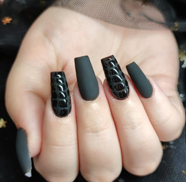 Coffin nails decorated with black crocodile nail art.