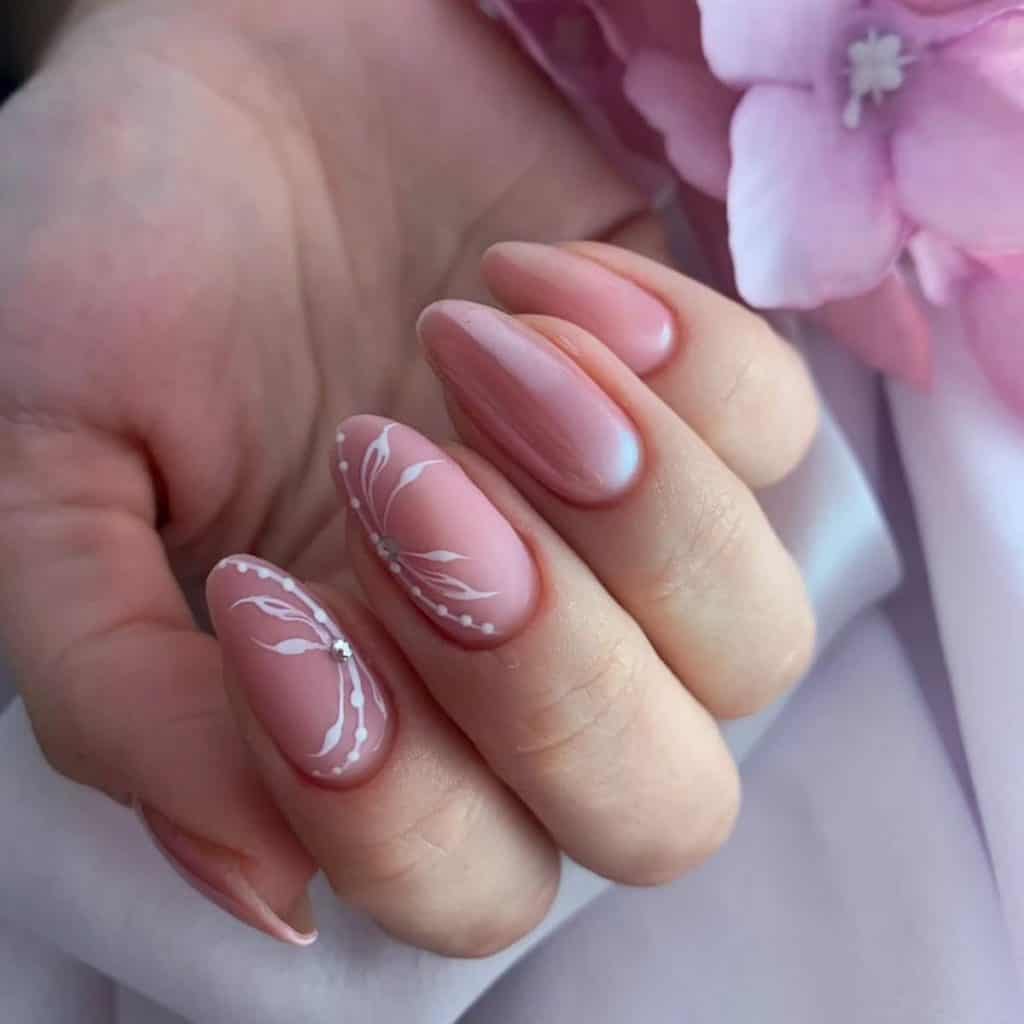 A woman's hand with pink nails and flowers.