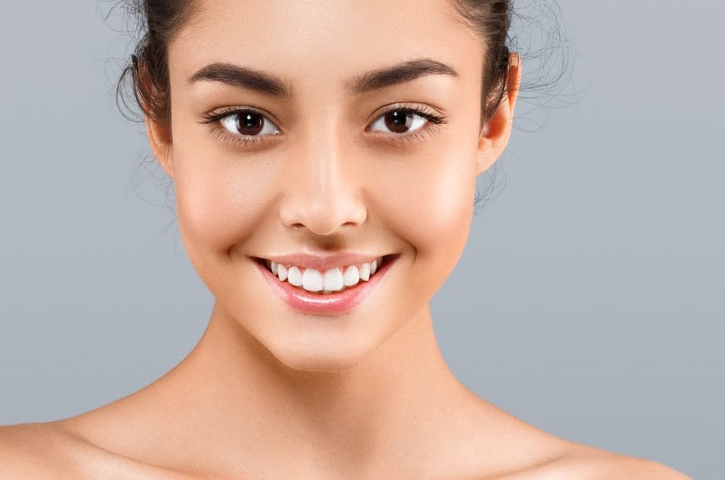 Beautiful woman face close up portrait with healthy skin and beauty concept