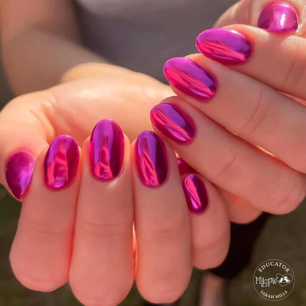 A woman's hands with hot pink chrome nails