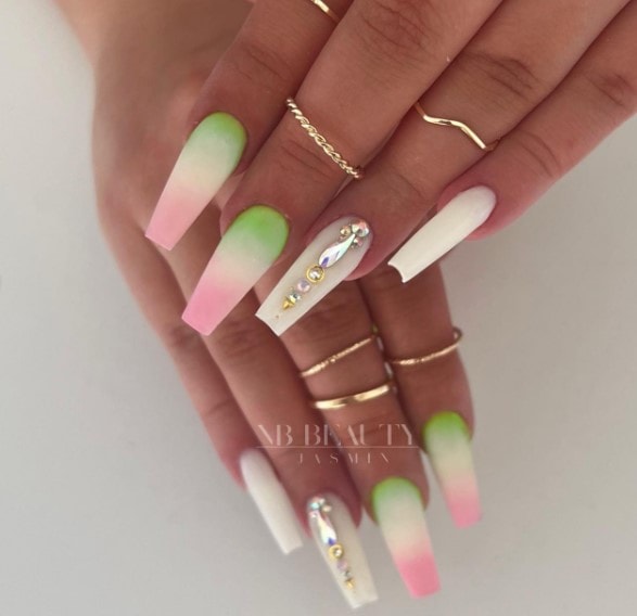 A woman's hand with two nails feature a gradient transitioning from mint green at the base to crisp white in the middle to soft pink at the tips