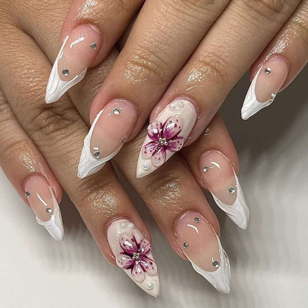 A woman's nails with rhinestones and white French tips, topped with embossed transparent swirls that give an illusion of gentle rain.
