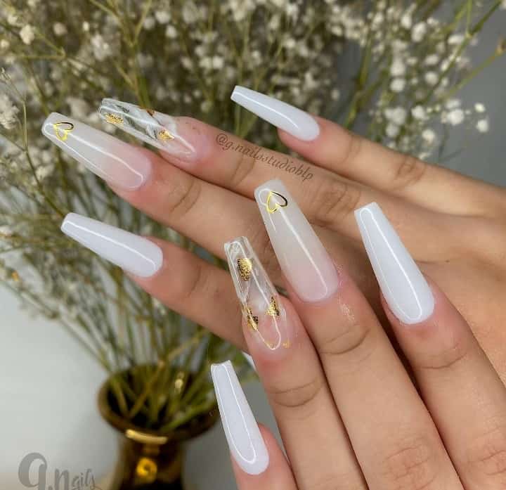 This mani features classic plain white nails and romantic soft milky white nails with a golden heart at the tips. Then, it takes it up a notch with the addition of transparent nails with soft white and gold marbling