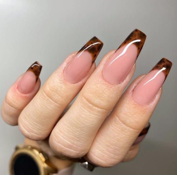 A woman's coffin nails with a leopard print design.