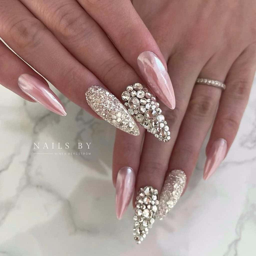 Long almond nails in chrome pink exude elegance with a touch of edgy flair featuring two accent nails