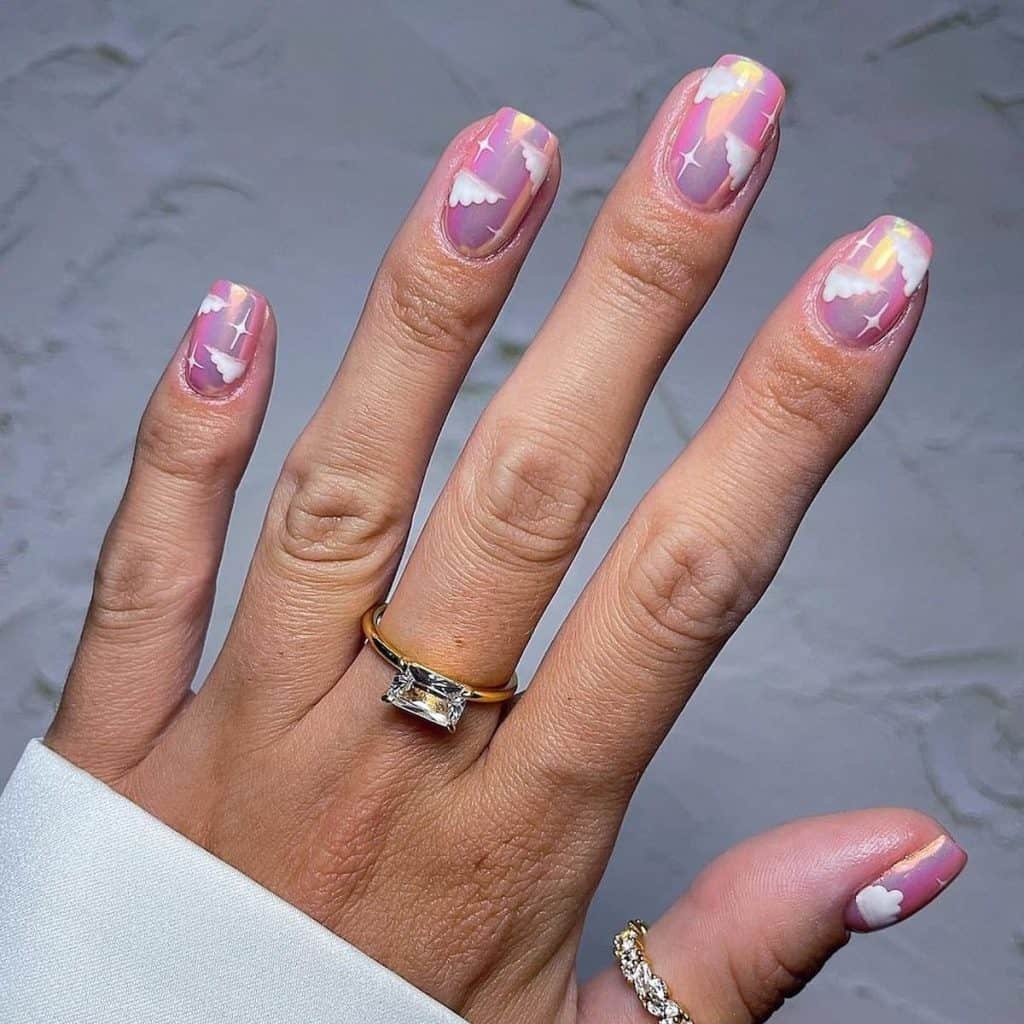 This pink chrome nail design will have you dreaming of a celestial escape with cloud art and twinkling stars in white set against a dreamy backdrop.