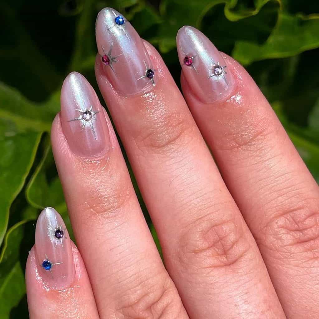 a woman's nude pink nails with star constellation design
