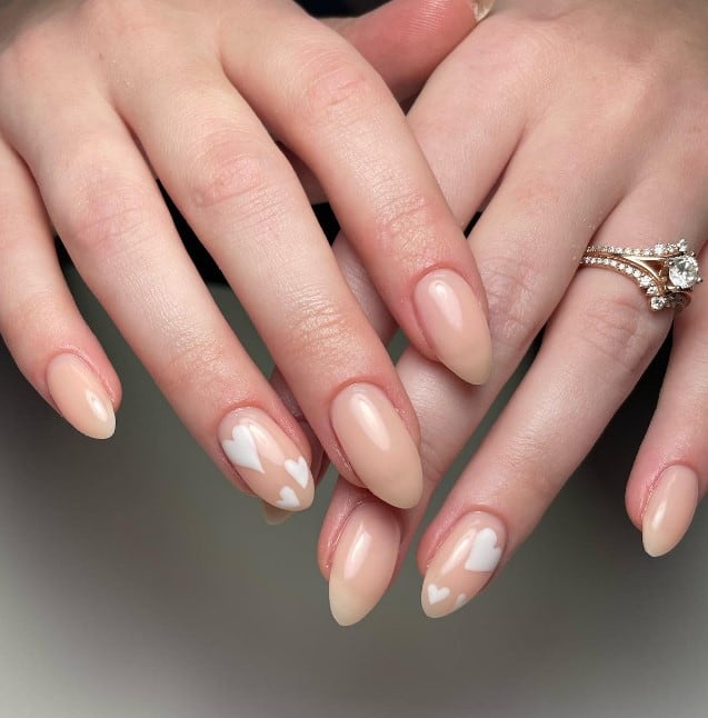 A trio of white hearts adorns one nail on each hand, adding a delicate and romantic flair to this graceful rose nail design.