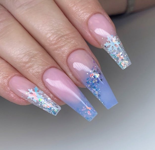 A woman's coffin nails with glitter in pink and blue.