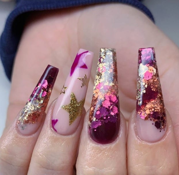 A woman's nude base nails blooms into magenta tips with encapsulated chunky glitter flakes
