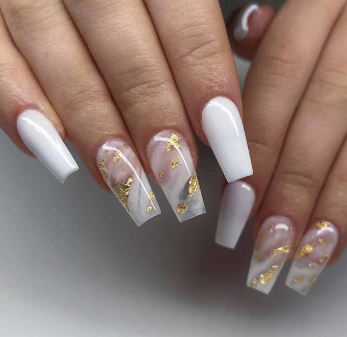 Long coffin nails keep it classy in plain white, while the accent nails add a layer of luxury with their marbled milky white smears and golden foil accents.