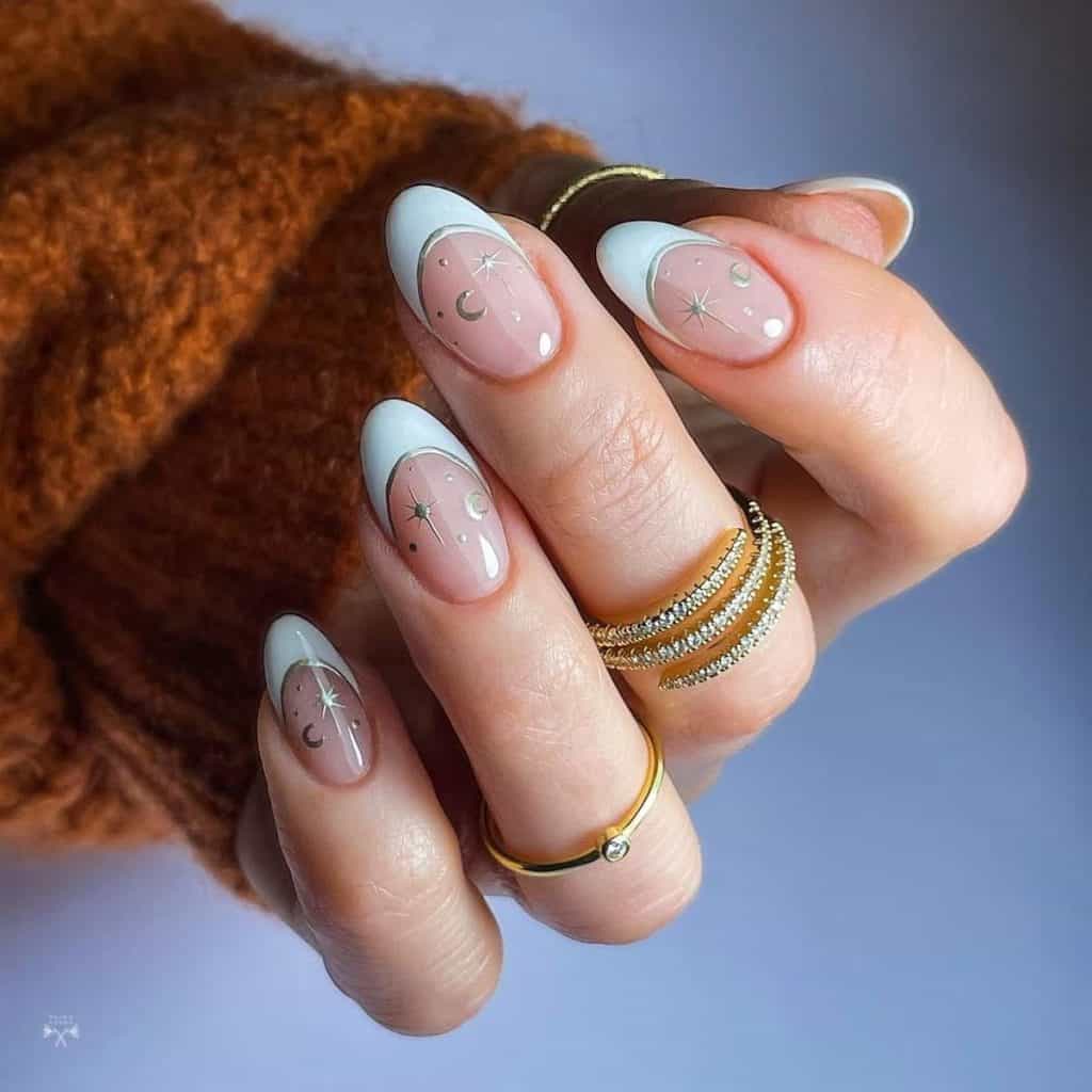 Flaunting pristine white French tips traced in silver chrome, the nude base is decorated with delicate dots, crescent moons, and North Star art, all gleaming in the same lustrous hue.
