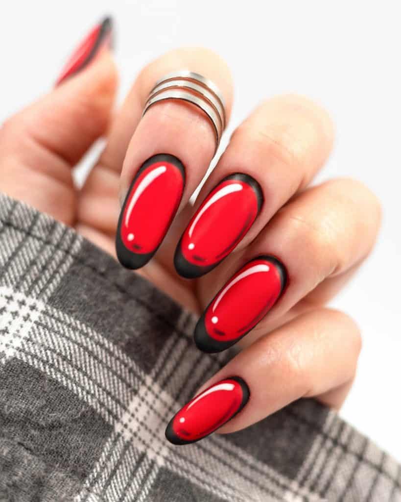 matte red nail is boldly outlined in black and highlighted with pops of white polish for a fun and graphic novel-inspired look