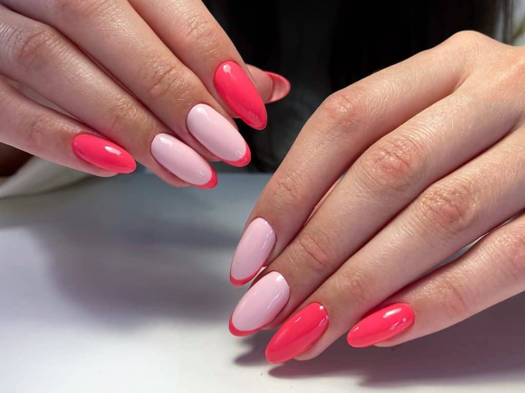 A woman's hands with pink and white nails.