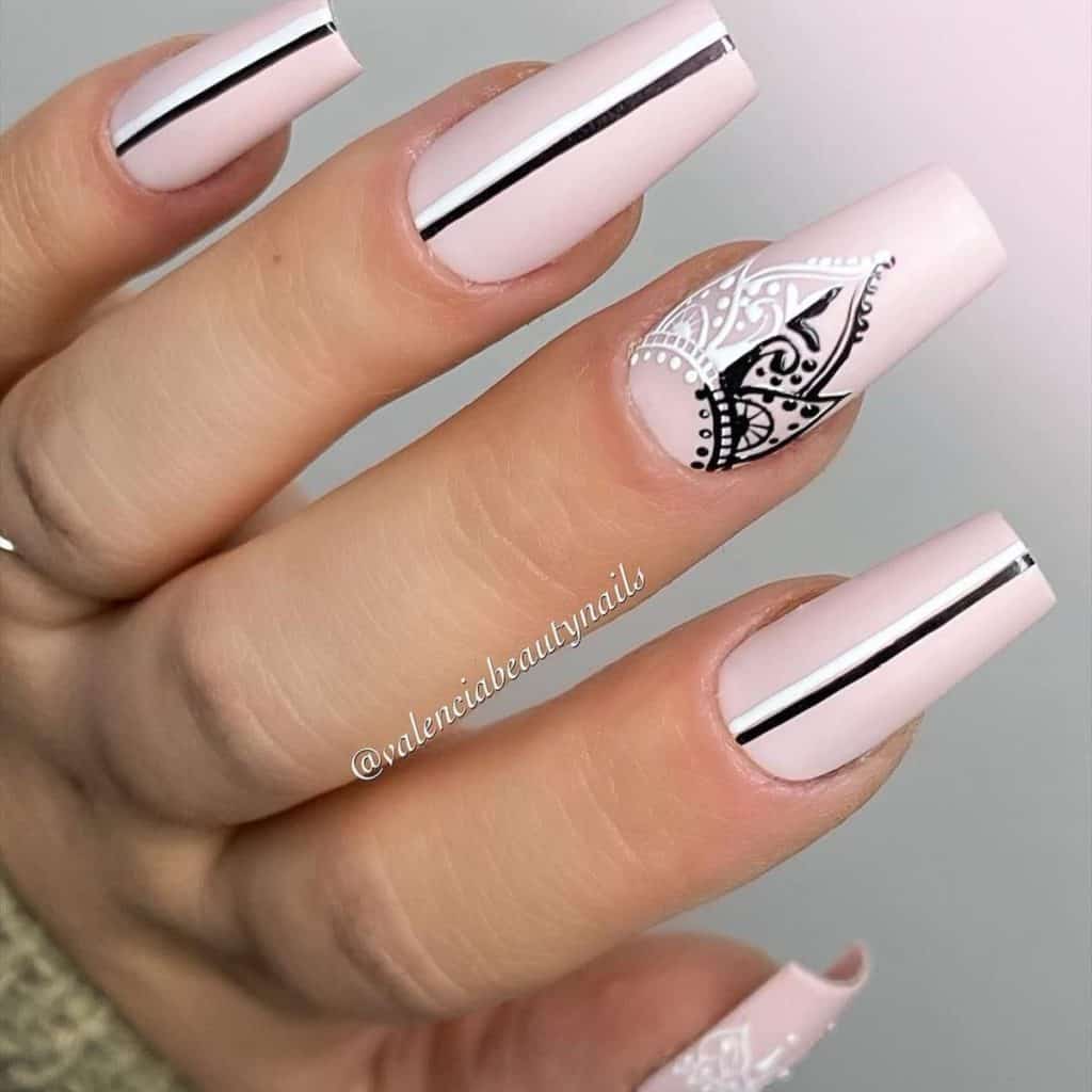 A woman's white, black, and pink matte nails
