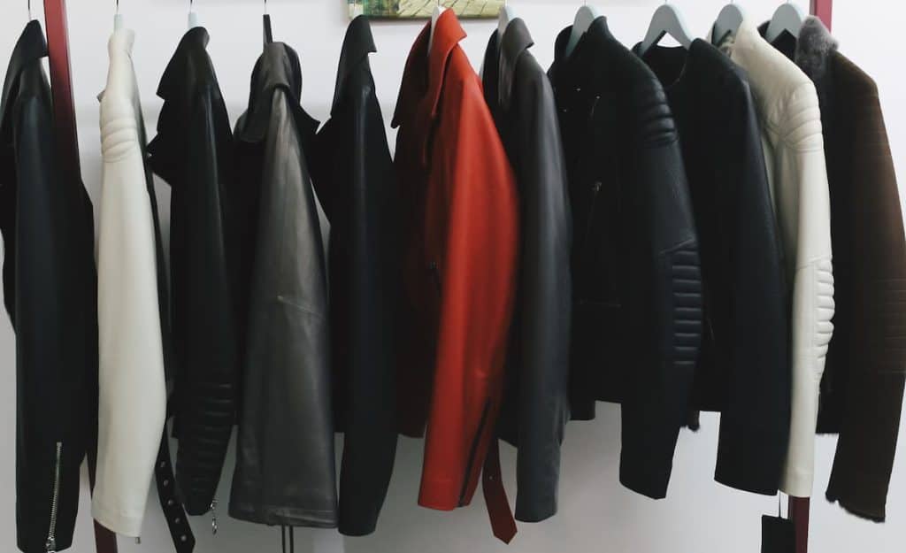 Collection of many new women's leather spring jackets on hangers in the shop.