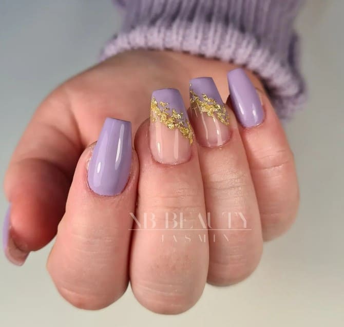This gorgeous light purple and gold nail design lets muted purple nails serve as a prelude to the drama of accent nails, which sport diagonal French tips with a trail of gold foil.