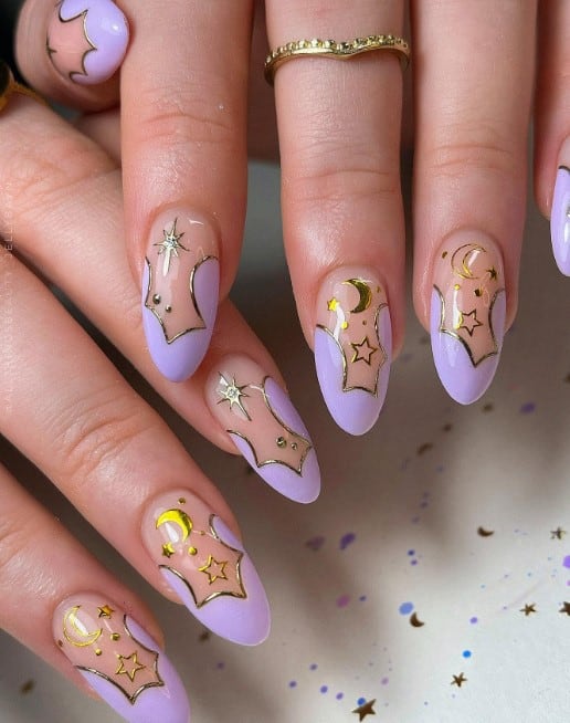 Cloud-shaped purple tips outlined in chrome gold bring whimsy and wonder to this nail design, along with a North Star, a crescent moon, and twinkling stars surrounded by tiny dots.